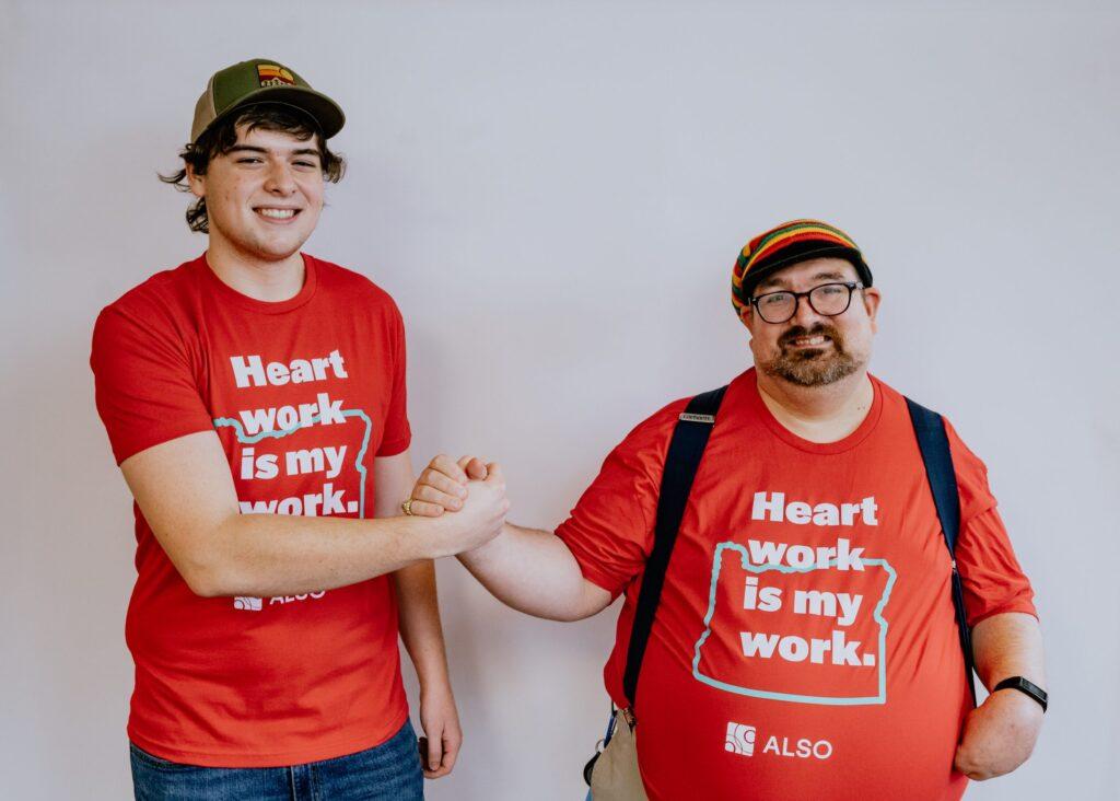A developmentally disabled man and DSP worker from ALSO clasp hands in a handshake.